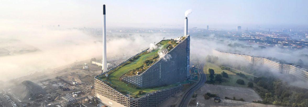 Aerial view of a waste to energy plant with a green public park running along its roofline